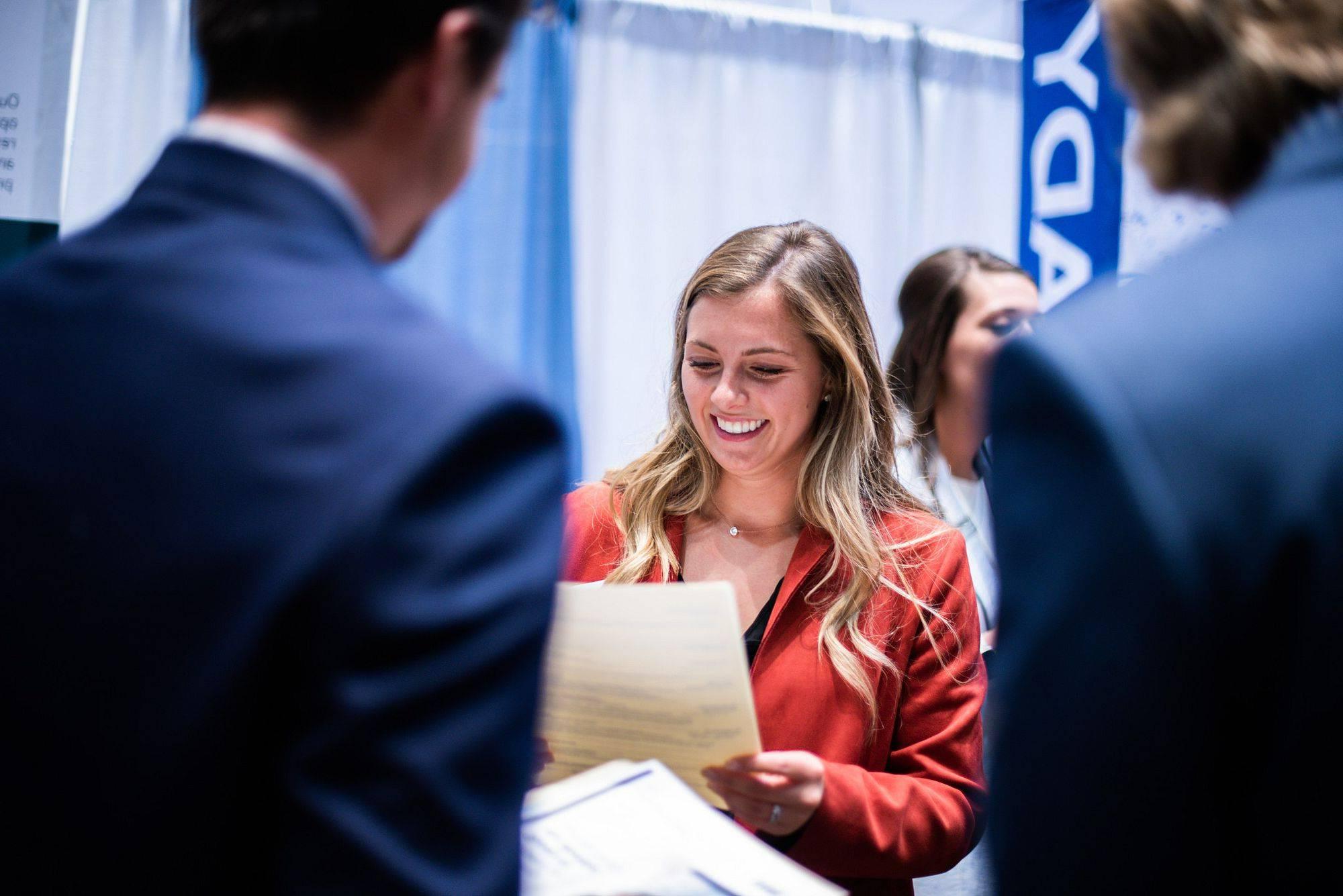 A student speaks with an employer at the GVSU Career Fair